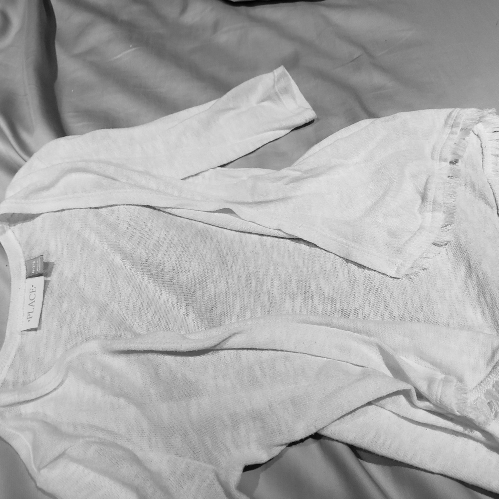 White 3/4s sleeve cardigan. Fringe on bottom